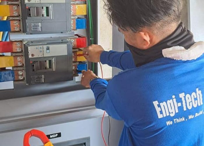 ENGI-TECH BUILDERS CORP. site personnel working on an electrical panel